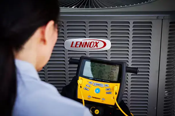 AC technician servicing a Lennox brand AC unit