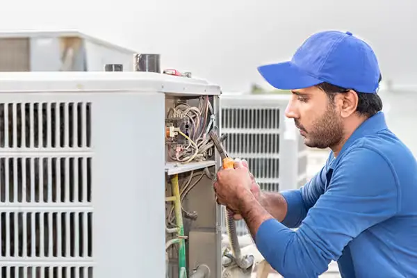 Repairman installing heating unit