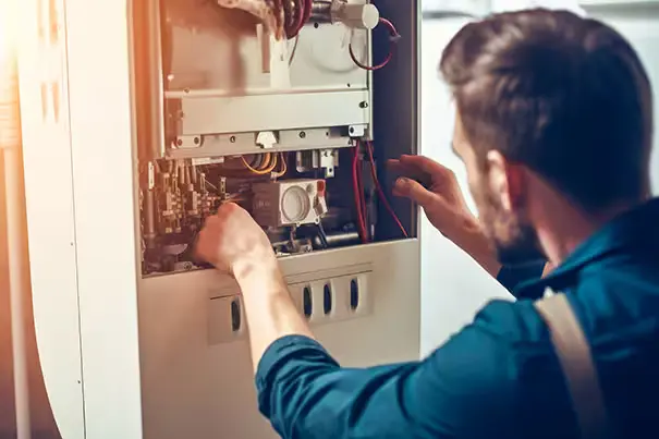 A technician repairing a heating system